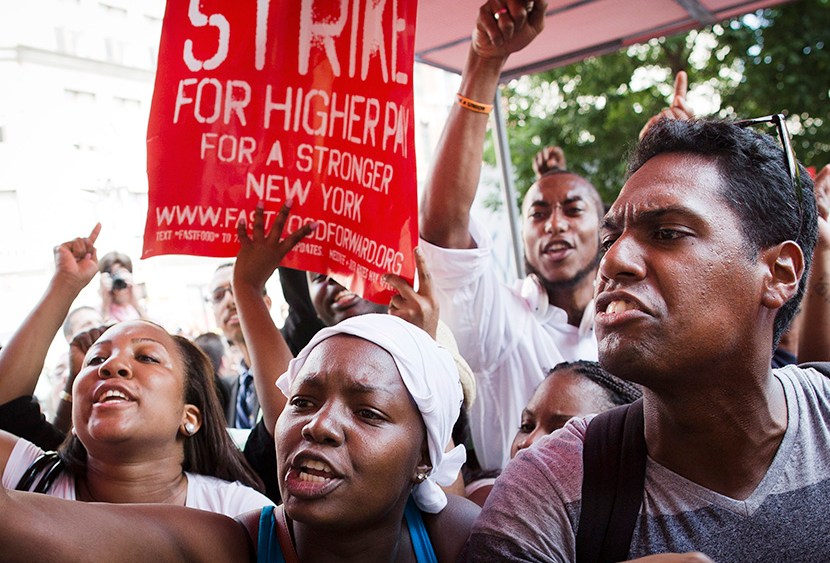 Demonstrators supporting fast food workers protest outside a McDonald's as they demand higher wages and the right to form a union without retaliation  Monday, July 29, 2013, in New York's Union Square.  (Photo by John Minchillo/AP)