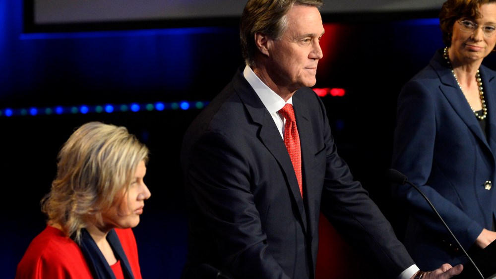 Georgia U.S. Senatorial candidates including Libertarian Amanda Swafford, left, Republican David Perdue, center, and Democrat Michelle Nunn, right, participate in a debate on Oct. 26, 2014, in Atlanta. (Photo by David Tulis/AP)