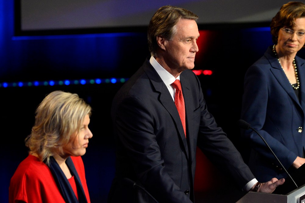 Georgia U.S. Senatorial candidates including Libertarian Amanda Swafford, left, Republican David Perdue, center, and Democrat Michelle Nunn, right, participate in a debate on Oct. 26, 2014, in Atlanta. (Photo by David Tulis/AP)