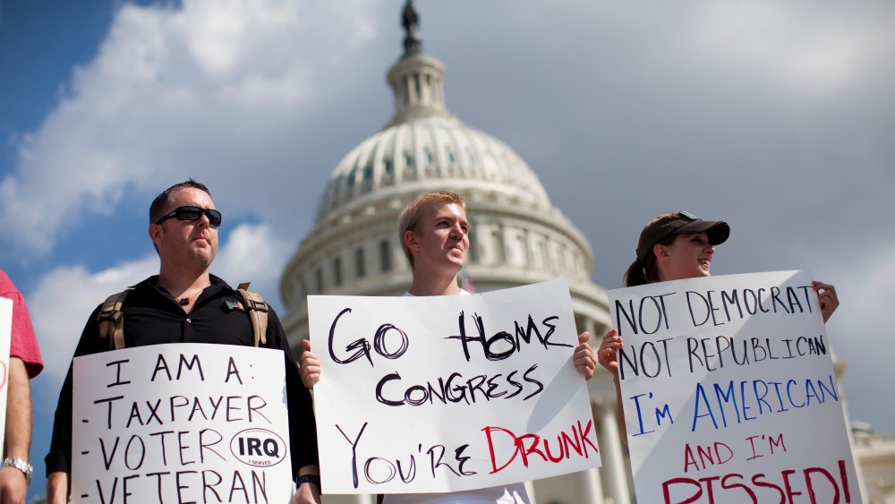 Protestors holds signs against the government shutdown on the West Front of the U.S. Capitol building on Capitol Hill on Friday, Oct. 4, 2013 in Washington.