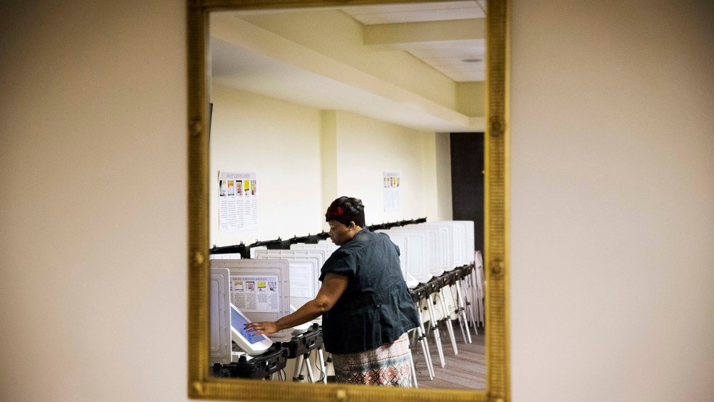 Tameika Ogburn, a polling site assistant manager, prepares voting machines before a voting location opens for Georgia's primary election, March 1, 2016, in Atlanta. (Photo by David Goldman/AP)