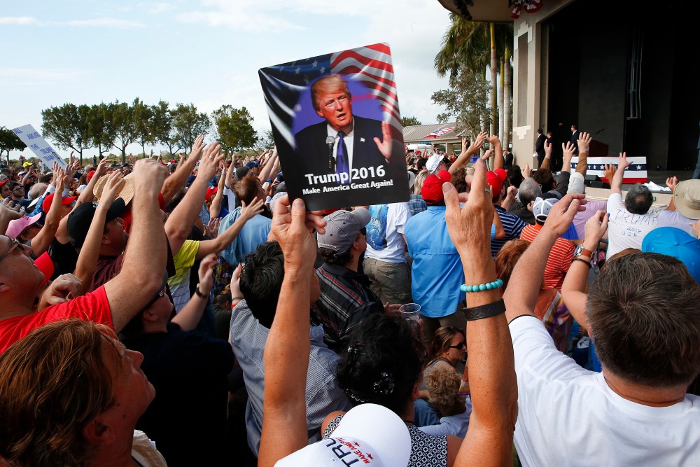 Audience members cheer at a Republican presidential candidate Donald Trump campaign rally in Boca Raton, Fl., March 13, 2016. (Photo by Paul Sancya/AP)