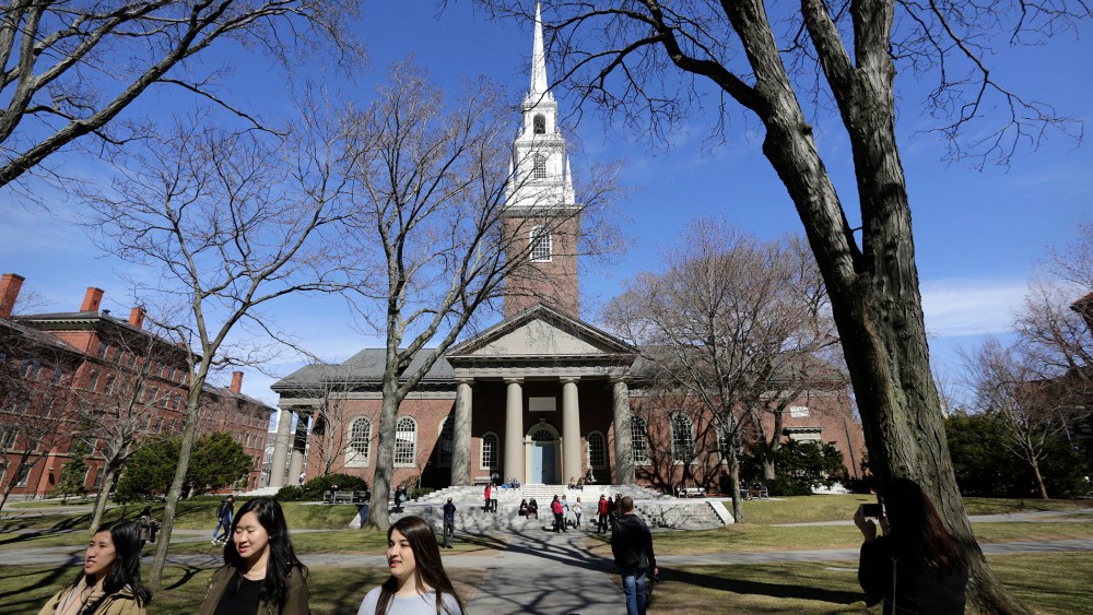 People walk near Memorial Church on the campus of Harvard University, in Cambridge, Mass., March 13, 2016. (Photo by Steven Senne/AP)
