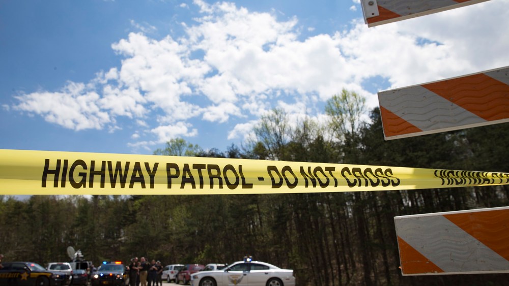 Police tape is deployed across from the Union Hill Road exit off Route 32 at a crime scene perimeter, April 22, 2016, in Pike County, Ohio. (Photo by John Minchillo/AP)