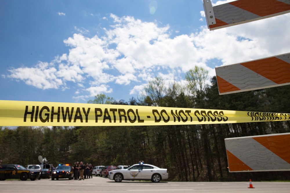 Police tape is deployed across from the Union Hill Road exit off Route 32 at a crime scene perimeter, April 22, 2016, in Pike County, Ohio. (Photo by John Minchillo/AP)