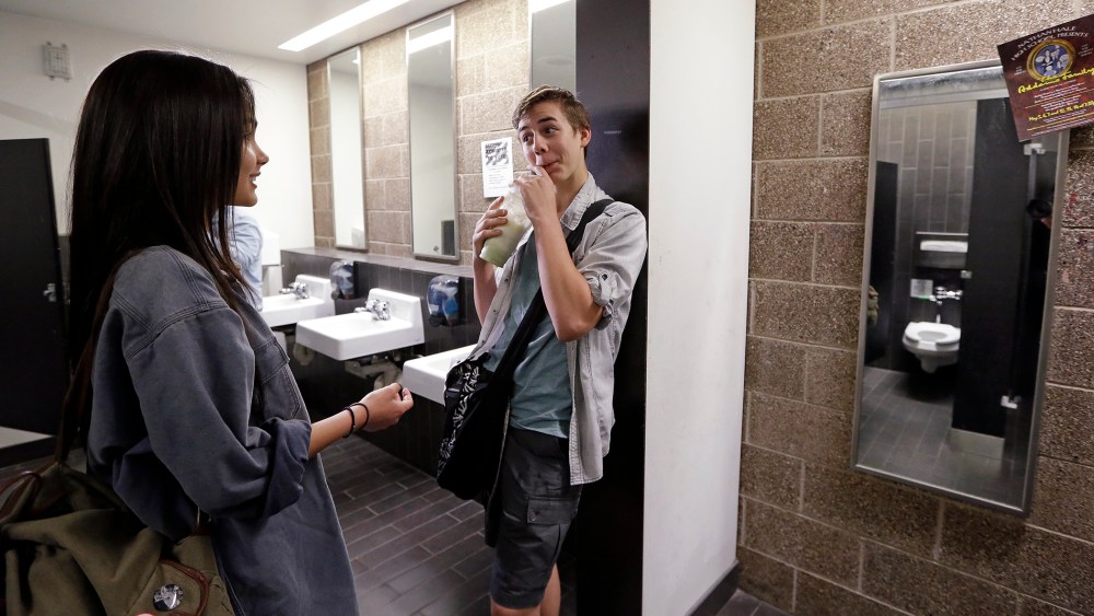 Ninth graders Tehya Vining, left, and Christian Jarboe talk after walking for the first time into a gender neutral bathroom at Nathan Hale high school, May 17, 2016, in Seattle. (Photo by Elaine Thompson/AP)