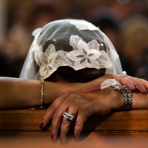 A Coptic Christian grieves during prayers for the departed, remembering the victims of Thursday's crash of EgyptAir flight 804, at Al-Boutrossiya Church, the main Coptic Cathedral complex, in Cairo, Egypt, May 22, 2016. (Photo by Amr Nabil/AP)