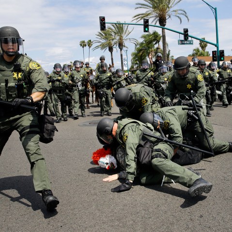 Orange County Sheriff's deputies take a protester into custody near the Anaheim Convention Center, May 25, 2016, in Anaheim, Calif. Republican presidential candidate Donald Trump held a rally at the convention center. (Photo by Jae C. Hong/AP)
