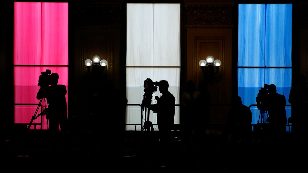 Television camera operators work from a platform as Democratic presidential candidate Hillary Clinton attends at a rally, May 26, 2016, in San Francisco, Calif. (Photo by John Locher/AP)