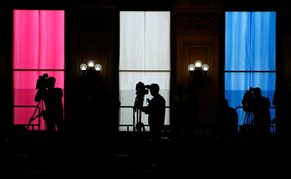 Television camera operators work from a platform as Democratic presidential candidate Hillary Clinton attends at a rally, May 26, 2016, in San Francisco, Calif. (Photo by John Locher/AP)
