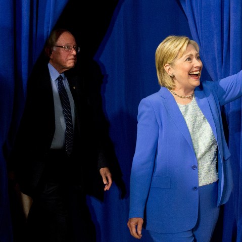 Democratic presidential candidate Hillary Clinton, followed by Sen. Bernie Sanders, I-Vt., waves as they arrive for a rally in Portsmouth, N.H., July 12, 2016, where Sanders endorsed Clinton for president. (Photo by Andrew Harnik/AP)