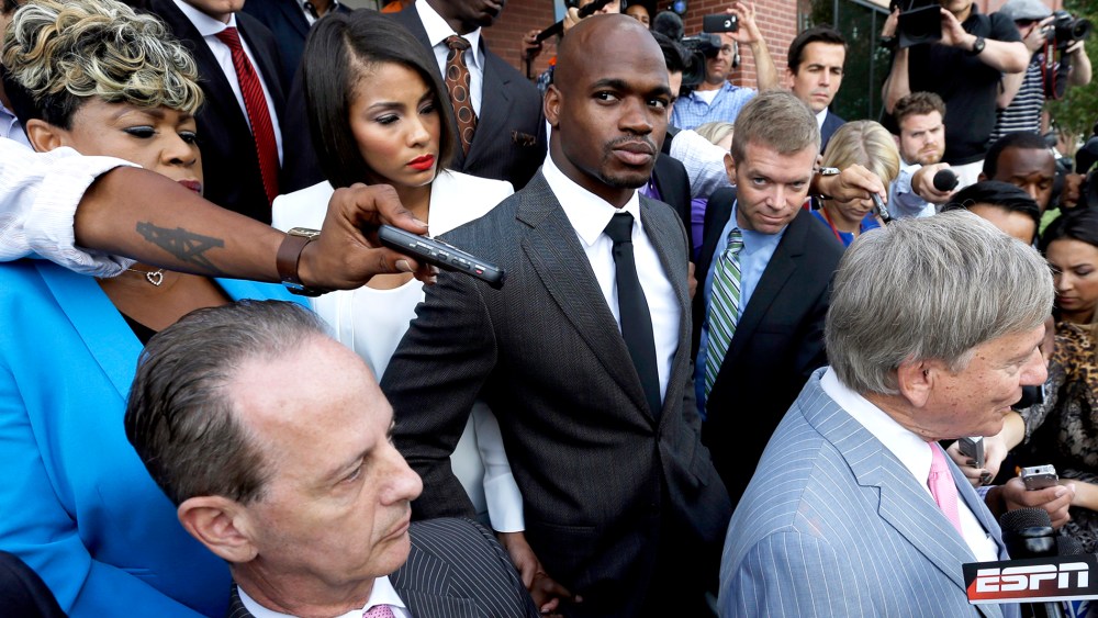Minnesota Vikings running back Adrian Peterson, center, stands outside the courthouse after making his first court appearance, Oct. 8, 2014, in Conroe, Texas. (Photo by David J. Phillip/Pool/AP)
