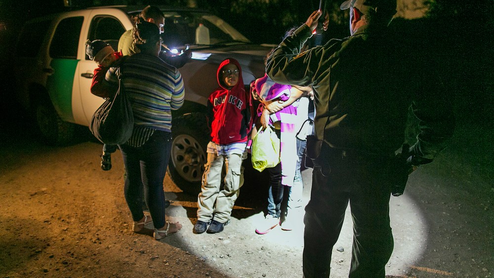 Mothers from Honduras traveling with their children prepare to get into a U.S. Customs and Border Protection Services agent's truck after crossing the Rio Grande near McAllen, Texas, July 3, 2014.