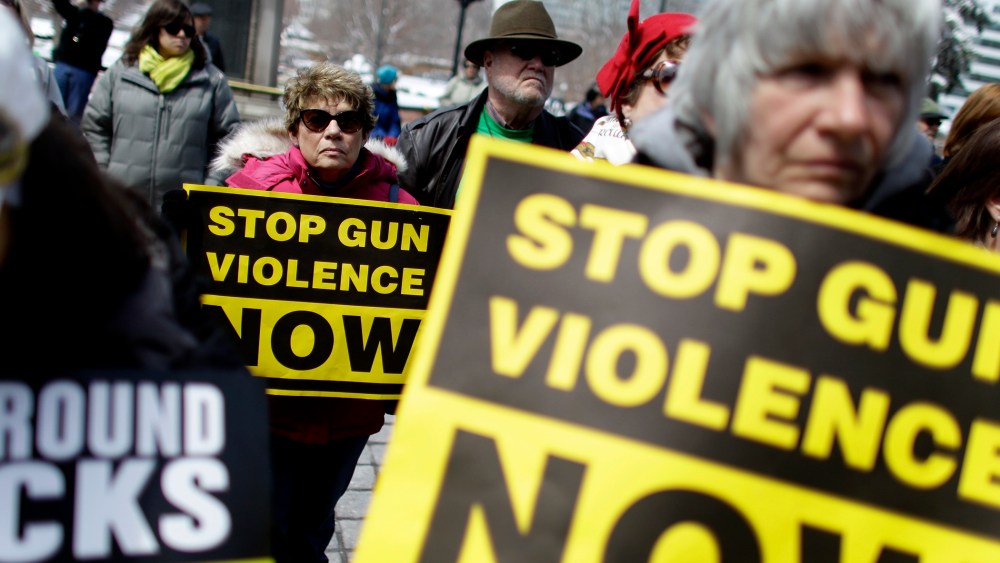 Community gun safety advocates and members of the public hold signs during a rally and vigil to honor victims of gun violence, sponsored by Colorado Ceasefire, on the steps of the Colorado State Capitol, in Denver, Thursday April 18, 2013.