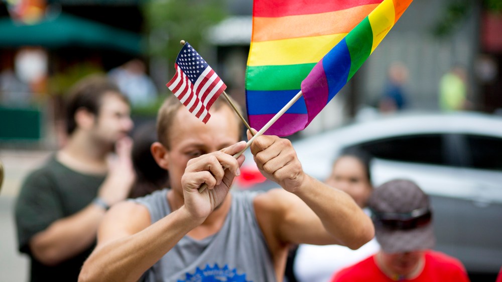 A man demonstrates outside the Miami court house during the court hearing on gay marriage in Miami, Fla. on July 2, 2014. (J Pat Carter/AP)
