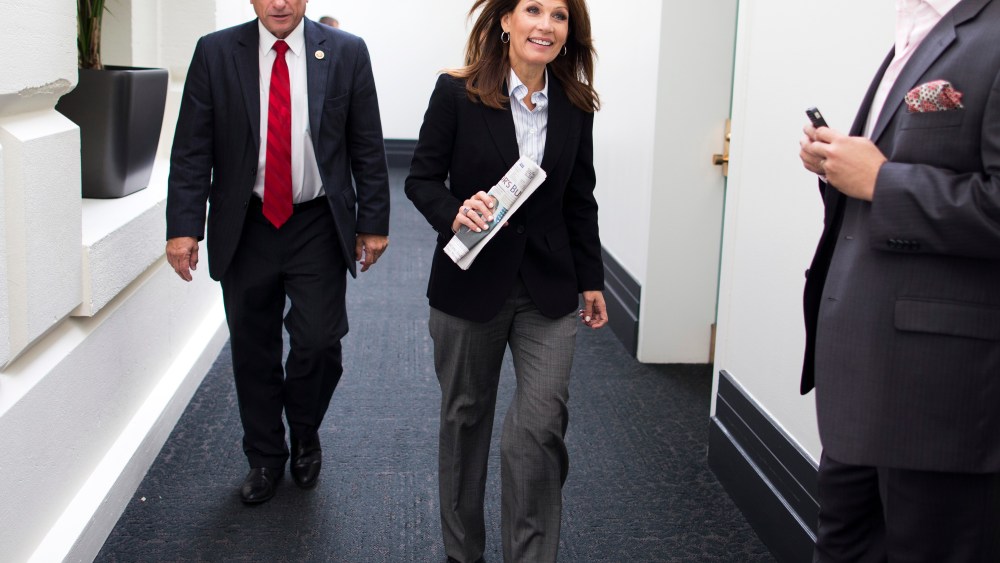 Rep. Steve King and Rep. Michele Bachmann leave a House Republican conference meeting on Capitol Hill on Saturday, Oct. 12, 2013 in Washington.