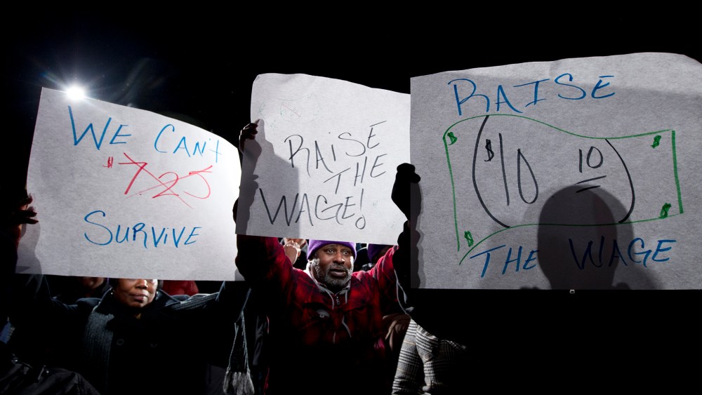 James Ray of Baltimore holds up his banner during a rally supporting to rise the state's minimum wage outside of the Maryland State House in Annapolis, Md, on Jan. 14, 2014.