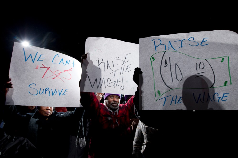 James Ray of Baltimore holds up his banner during a rally supporting to rise the state's minimum wage outside of the Maryland State House in Annapolis, Md, on Jan. 14, 2014.