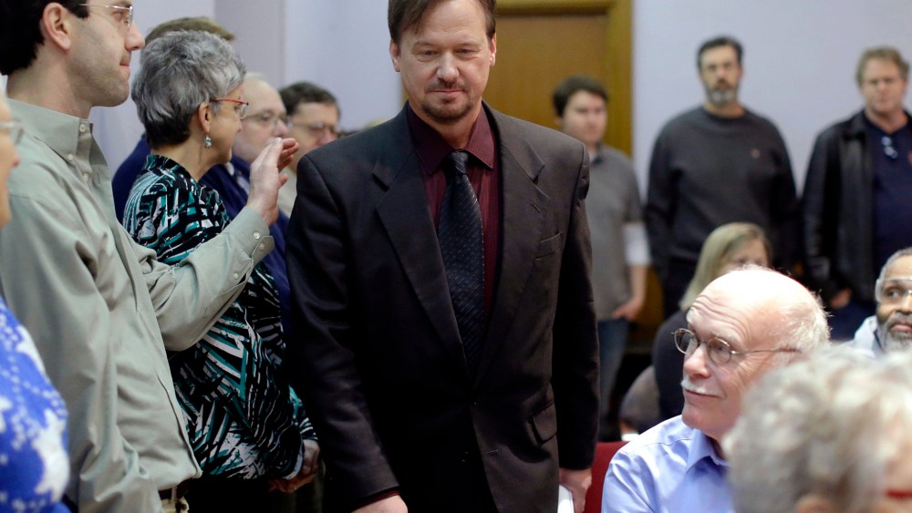 A man places a hand on the shoulder of The Rev. Frank Schaefer, a United Methodist clergyman convicted of breaking church law for officiating at his son's same-sex wedding, as he enters a news conference, Dec. 16, 2013, at the Arch Street United Methodist