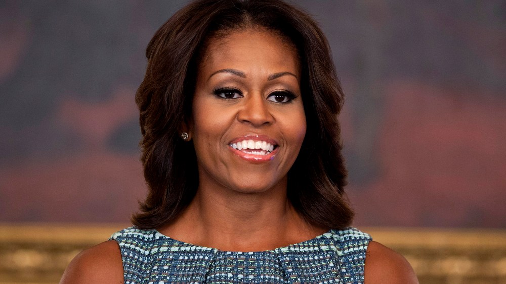First lady Michelle Obama pauses during an event in the State Dining Room of the White House on Sept. 18, 2013, in Washington, D.C. (Photo by Evan Vucci/AP)