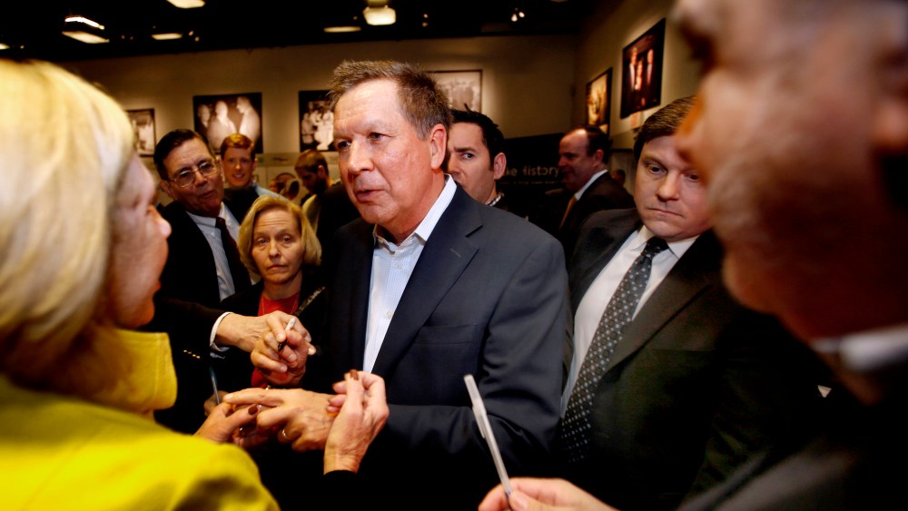 Ohio Gov. John Kasich, R-Ohio is greeted after speaking at a breakfast with state political activist and area business leaders hosted by the New Hampshire Institute of Politics at Saint Anselm College, March 24, 2015. (Photo by Jim Cole/AP)