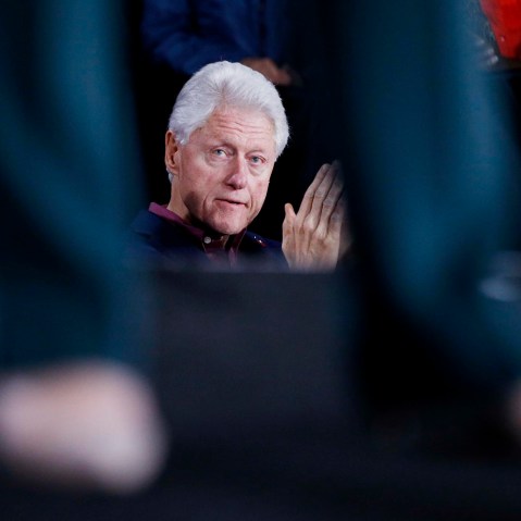 Former President Bill Clinton listens to Democratic presidential candidate Hillary Clinton speak during a rally, Feb. 19, 2016, in Las Vegas. (Photo by John Locher/AP)