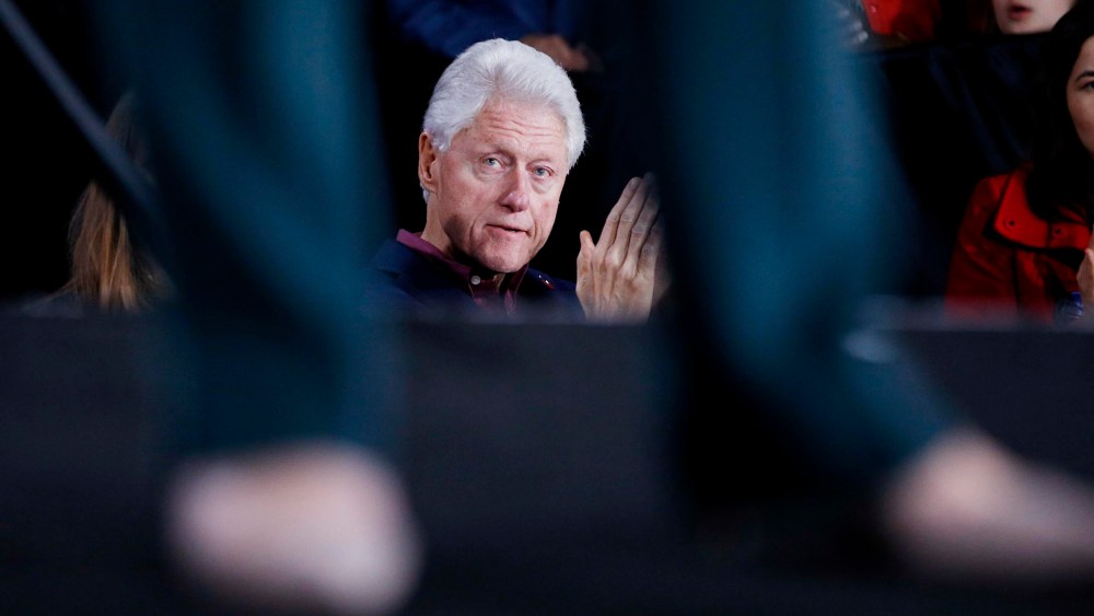 Former President Bill Clinton listens to Democratic presidential candidate Hillary Clinton speak during a rally, Feb. 19, 2016, in Las Vegas. (Photo by John Locher/AP)