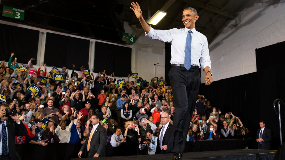 President Barack Obama waves after being introduced during an event on Oct. 30, 2014, in Portland, Maine. (Photo by Evan Vucci/AP)