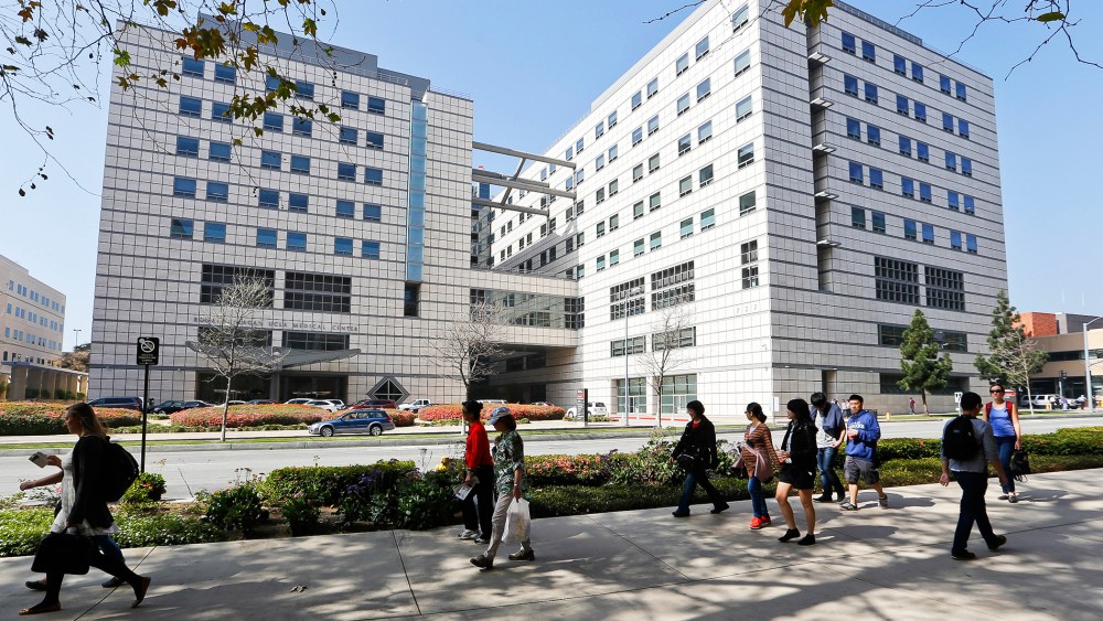 People walk near the Ronald Reagan UCLA Medical Center in Los Angeles building in Los Angeles, Calif., Feb. 19, 2015. (Photo by Damian Dovarganes/AP)
