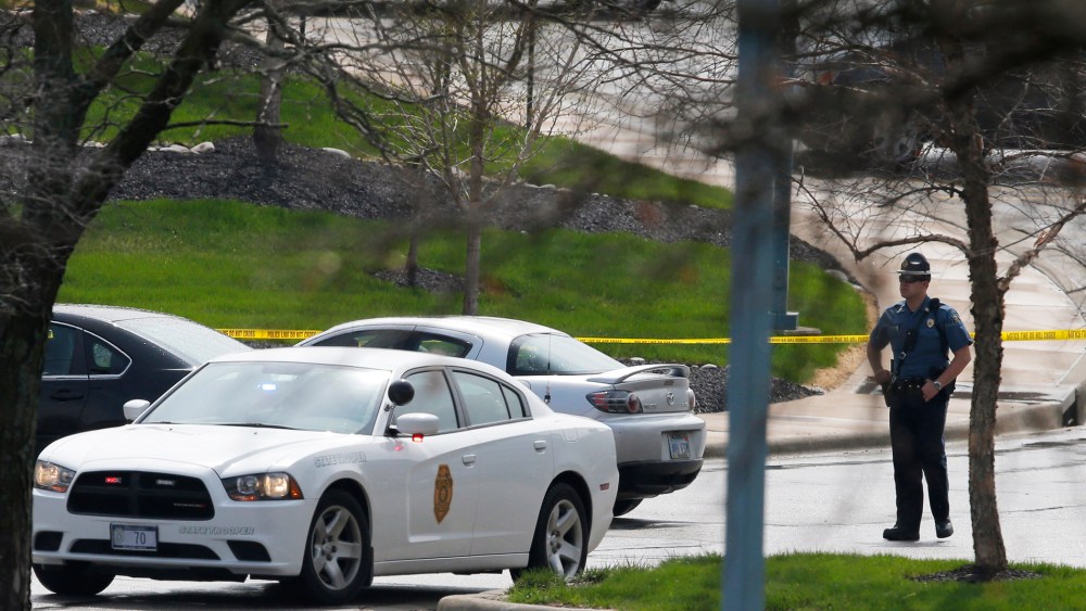 A Kansas State Trooper stands near the location of a shooting at the Jewish Community Center in Overland Park, Kan., April 13, 2014.