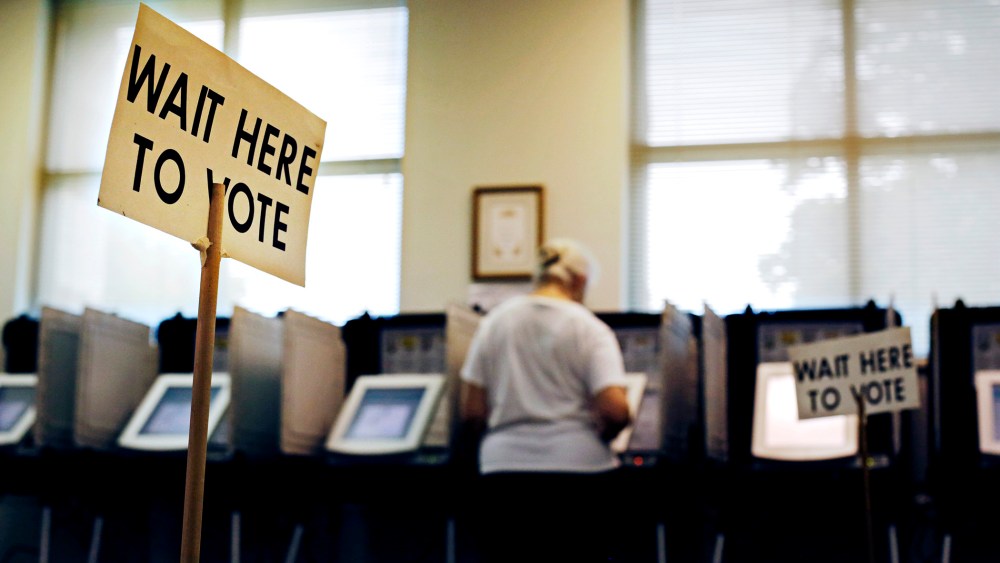 A sign greets voters before they step up to cast their ballot at a polling site, Tuesday, July 22, 2014, in Atlanta.