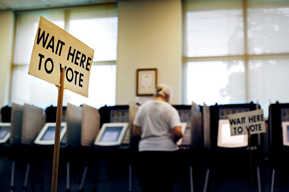 A sign greets voters before they step up to cast their ballot at a polling site, Tuesday, July 22, 2014, in Atlanta.
