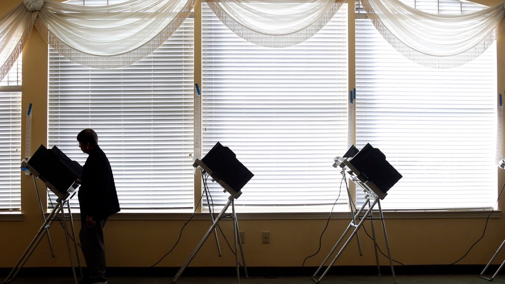 A voter casts her electronic ballot, Nov. 4, 2014 at her precinct in Madison, Miss. (Photo by Rogelio V. Solis/AP)