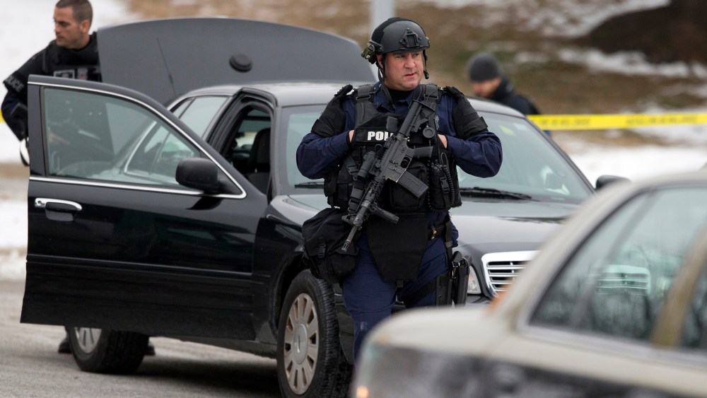 Police walk on the scene after a shooting at The Mall in Columbia on Jan. 25, 2014 in Columbia, Md.