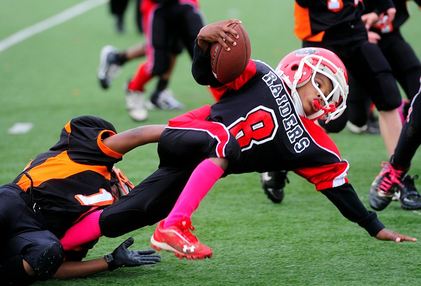 Eastern York County's Isaiah Jones, 8, brings down Zamir Weedon-Parker, 8, in the second half of the rink varsity semifinal game at Central York High School on Oct. 28, 2012. Football had the highest concussion rate, according to the “Game Changers”...