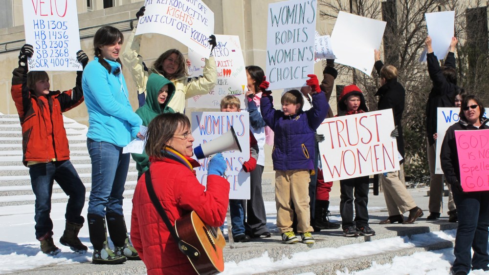 In this March 25, 2013, file photo Kris Kitko, left, leads chants of protest at an abortion-rights rally at the state Capitol in Bismarck, N.D. (Photo by James MacPherson/AP)