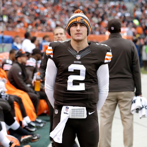 Cleveland Browns quarterback Johnny Manziel (2) watches from the sidelines in the first quarter of an NFL football game against the Cincinnati Bengals, Dec. 14, 2014, in Cleveland, Ohio. (Photo by Tony Dejak/AP)