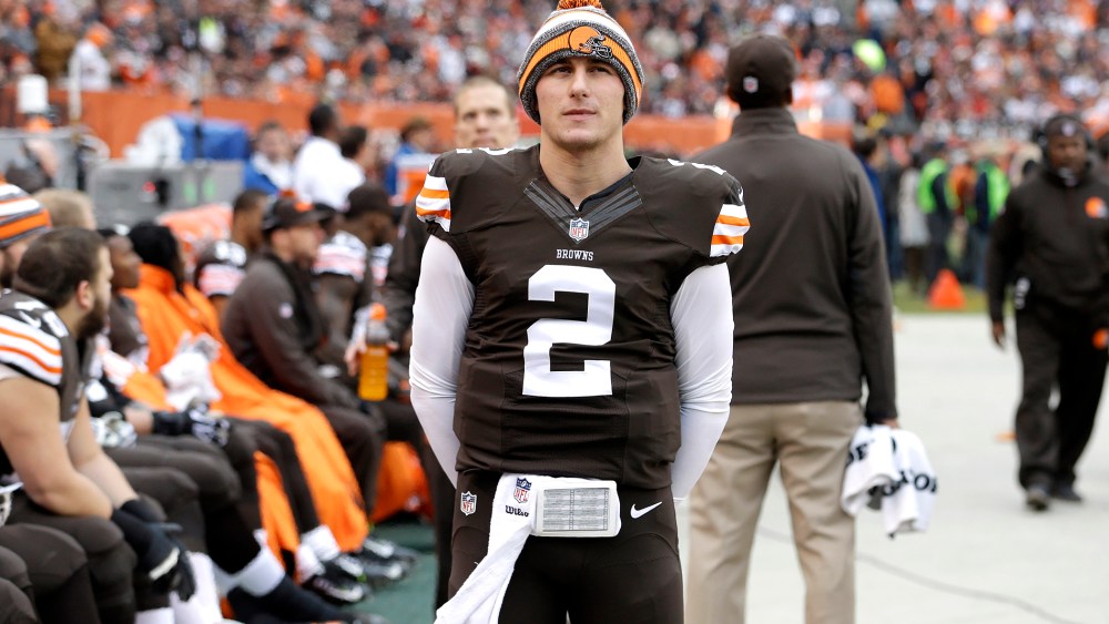 Cleveland Browns quarterback Johnny Manziel (2) watches from the sidelines in the first quarter of an NFL football game against the Cincinnati Bengals, Dec. 14, 2014, in Cleveland, Ohio. (Photo by Tony Dejak/AP)