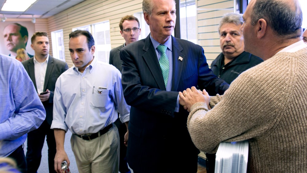 Dan Donovan, center, currently the district attorney of the Staten Island borough of New York, greets a supporter in one of two campaign offices opened Sunday, March 22, 2015. (Photo by Craig Ruttle/AP)