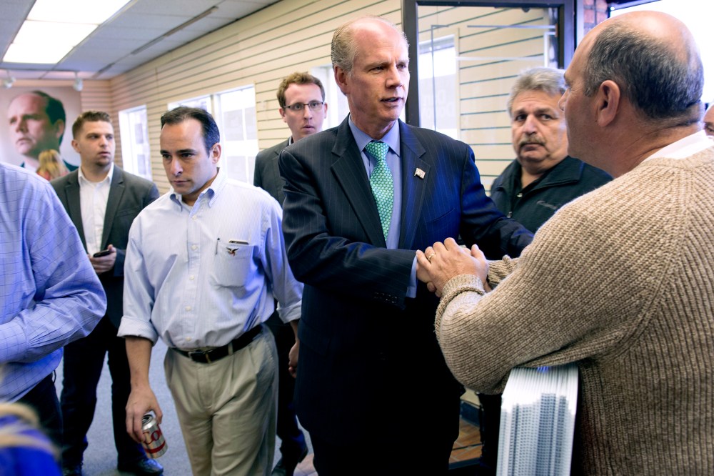 Dan Donovan, center, currently the district attorney of the Staten Island borough of New York, greets a supporter in one of two campaign offices opened Sunday, March 22, 2015. (Photo by Craig Ruttle/AP)