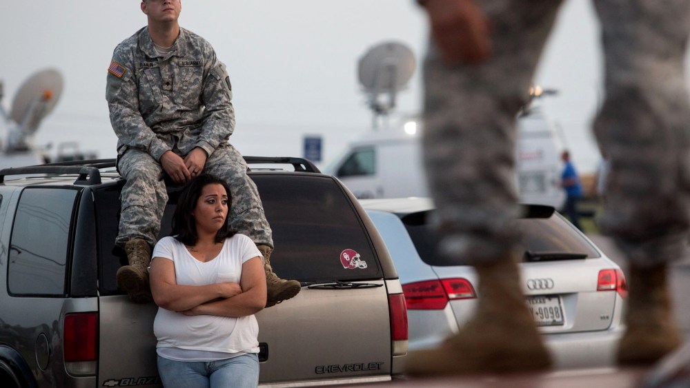 Lucy Hamlin and her husband, Spc. Timothy Hamlin, wait for permission to re-enter the Fort Hood military base, where they live, following a shooting on base on April 2, 2014, in Fort Hood, Texas.