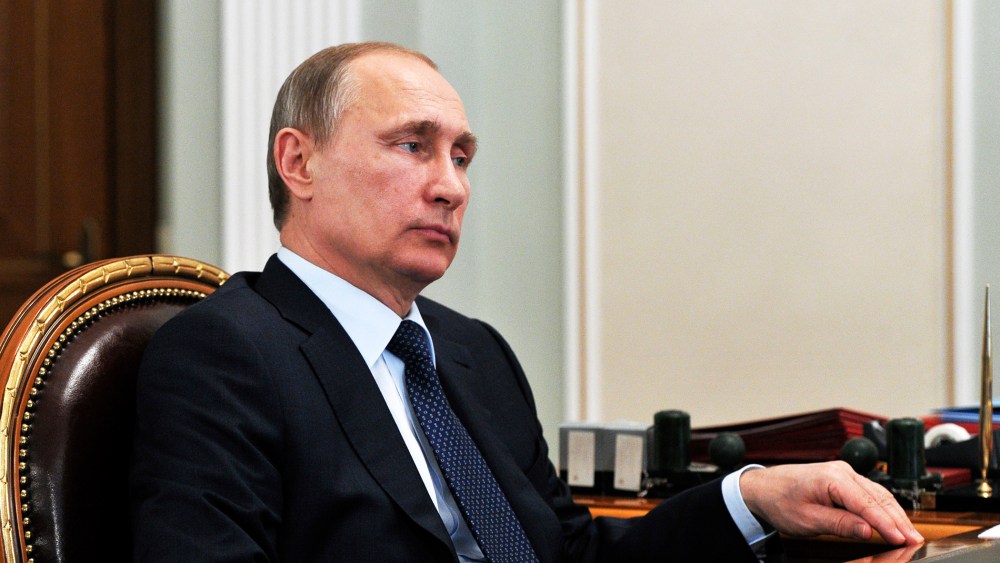 Russian President Vladimir Putin listens during a meeting in the Novo Ogaryovo residence, outside Moscow on, April 13, 2015. (Photo by Mikhail Klimentyev/AP)