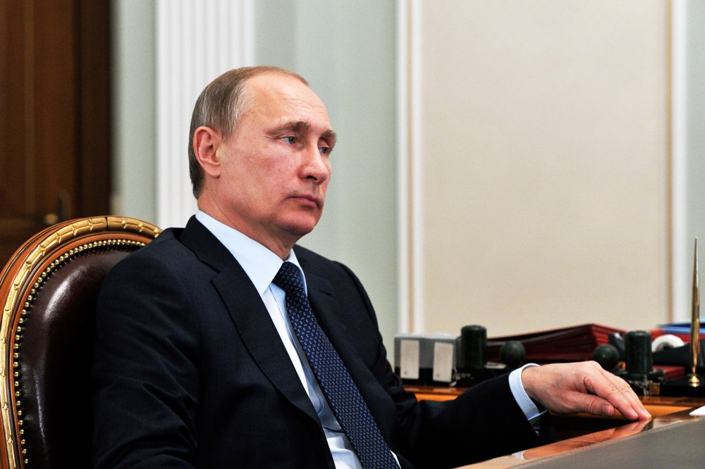 Russian President Vladimir Putin listens during a meeting in the Novo Ogaryovo residence, outside Moscow on, April 13, 2015. (Photo by Mikhail Klimentyev/AP)