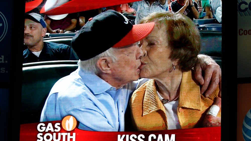 Former President Jimmy Carter kisses his wife, Rosalynn, on the "Kiss Cam" during a baseball game between the Atlanta Braves and the Toronto Blue Jays, Sept. 17, 2015, in Atlanta. (Photo by John Bazemore/AP)