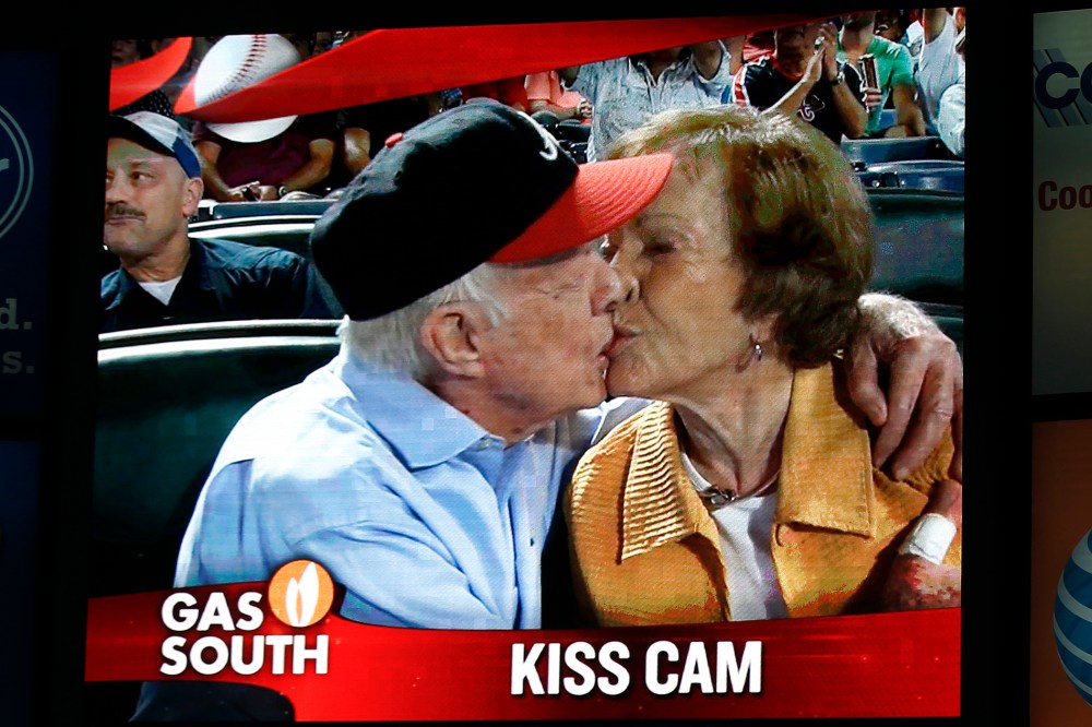 Former President Jimmy Carter kisses his wife, Rosalynn, on the "Kiss Cam" during a baseball game between the Atlanta Braves and the Toronto Blue Jays, Sept. 17, 2015, in Atlanta. (Photo by John Bazemore/AP)