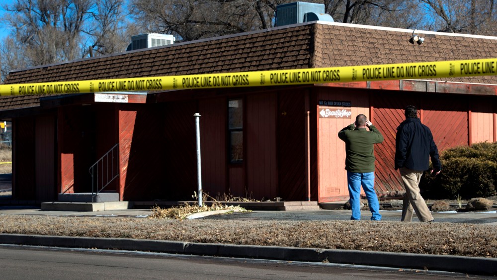 Colorado Springs police officers investigate the scene of an explosion on Jan. 6, 2015, at a building in Colorado, which houses a barber shop and the Colorado Springs chapter of the NAACP. (AP Photo/The Colorado Springs Gazette, Christian Murdock)