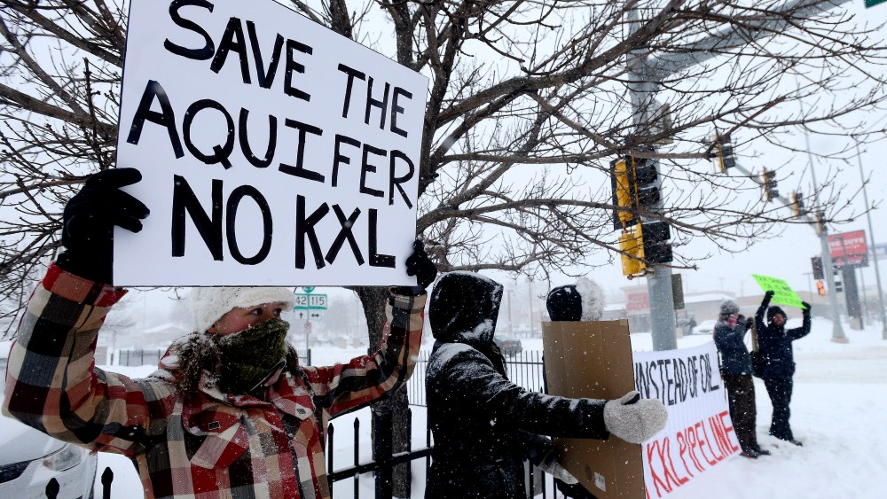 Valerie Schonewill and several others protest the proposed Keystone XL pipeline, Jan. 5, 2015, in Sioux Falls, S.D. (AP Photo/Argus Leader, Elisha Page)