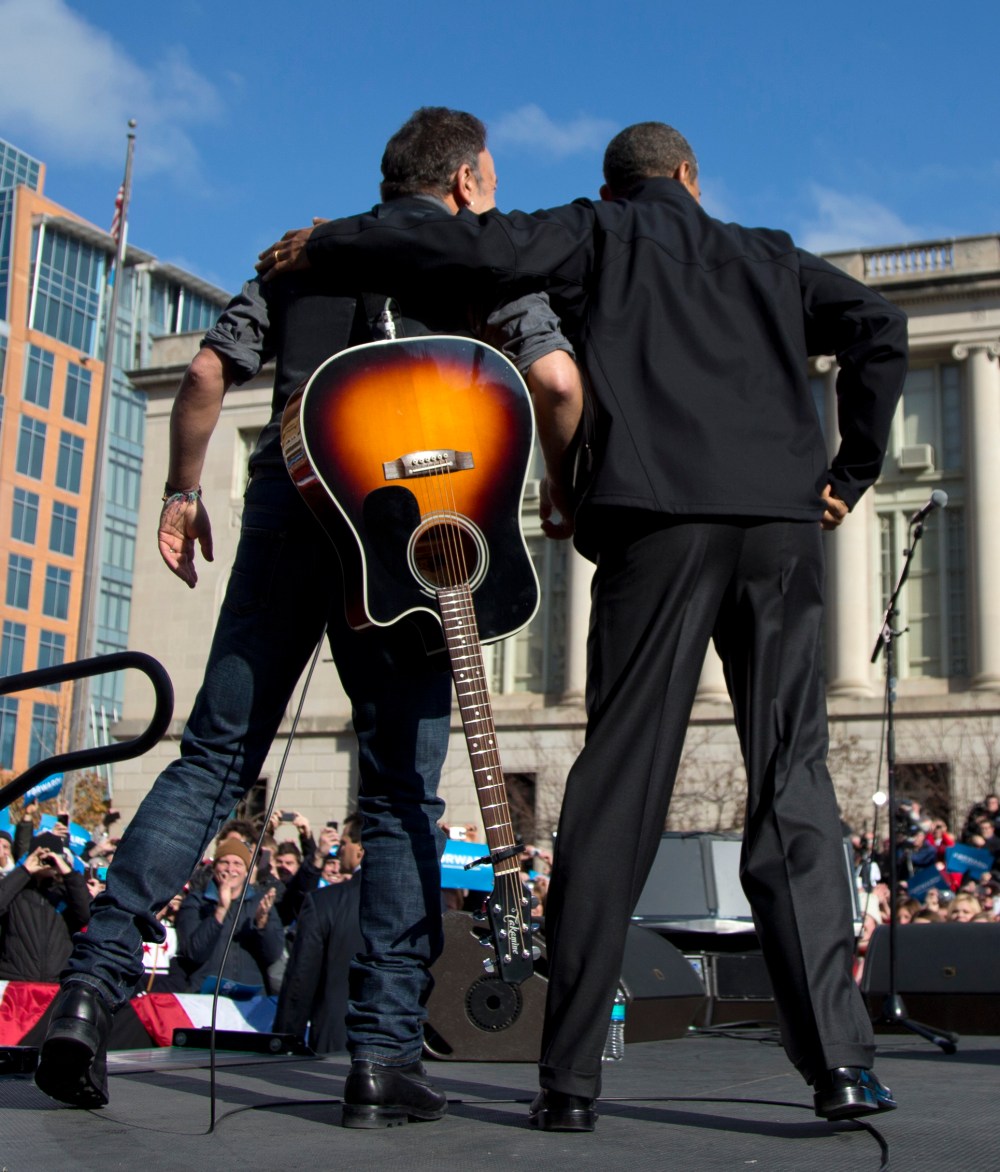 President Barack Obama and singer Bruce Springsteen stand together on stage during a campaign event, Monday, Nov. 5, 2012, in downtown Madison, Wis.  (AP Photo/Carolyn Kaster)