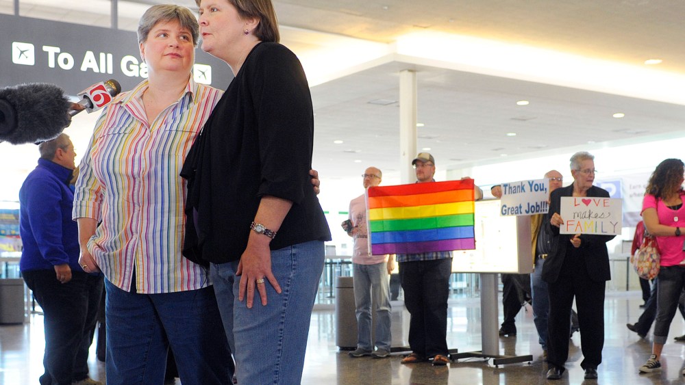Sharon Baldwin, left, and her partner Mary Bishop speak with members of the media before boarding a plane to Denver at Tulsa International Airport, on April 16, 2014.