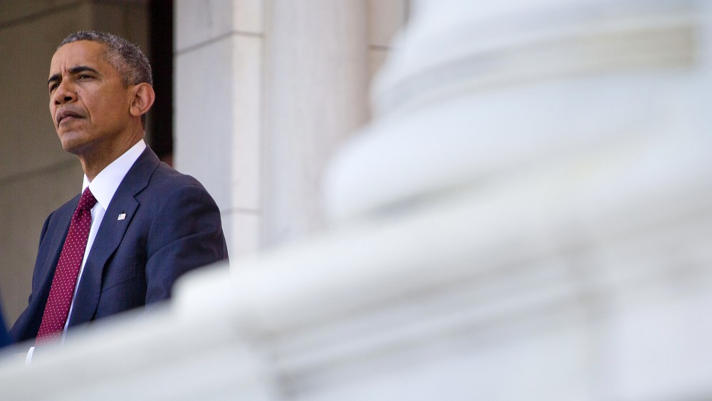 President Barack Obama listens as Defense Secretary Ash Carter speaks in the Memorial Amphitheater at Arlington National Cemetery in Arlington, Va., on May 25, 2015. (Photo by Pablo Martinez Monsivais/AP)